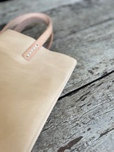 Load image into Gallery viewer, natural vegetable tanned leather bags small size, narrow-rectangular flat shape. two veg tan handles attached/sewn using belgian linen yarn. also made in distressed brown & black leather and black & tan suede. Retail price $195.