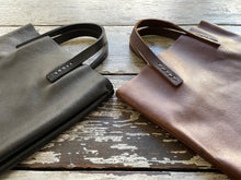 Load image into Gallery viewer, Black and brown leather bags small size, narrow-rectangular flat shape. two veg tan handles attached/sewn using belgian linen yarn. also made in natural vegetable tanned leather and black & tan suede. Retail price $195.