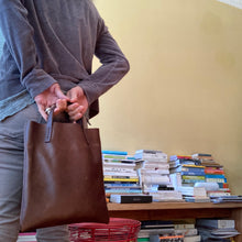 Load image into Gallery viewer, Black and brown leather bags small size, narrow-rectangular flat shape. two veg tan handles attached/sewn using belgian linen yarn. also made in natural vegetable tanned leather and black & tan suede. Retail price $195.