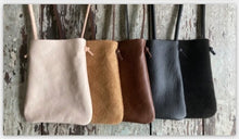 Load image into Gallery viewer, multiple colors of x-small crossbody bags. in a row-- veg tan leather, tan suede, brown leather, black leather and black suede. bottom corners of the bag are rounded.  This bag is artisan made and handcrafted.